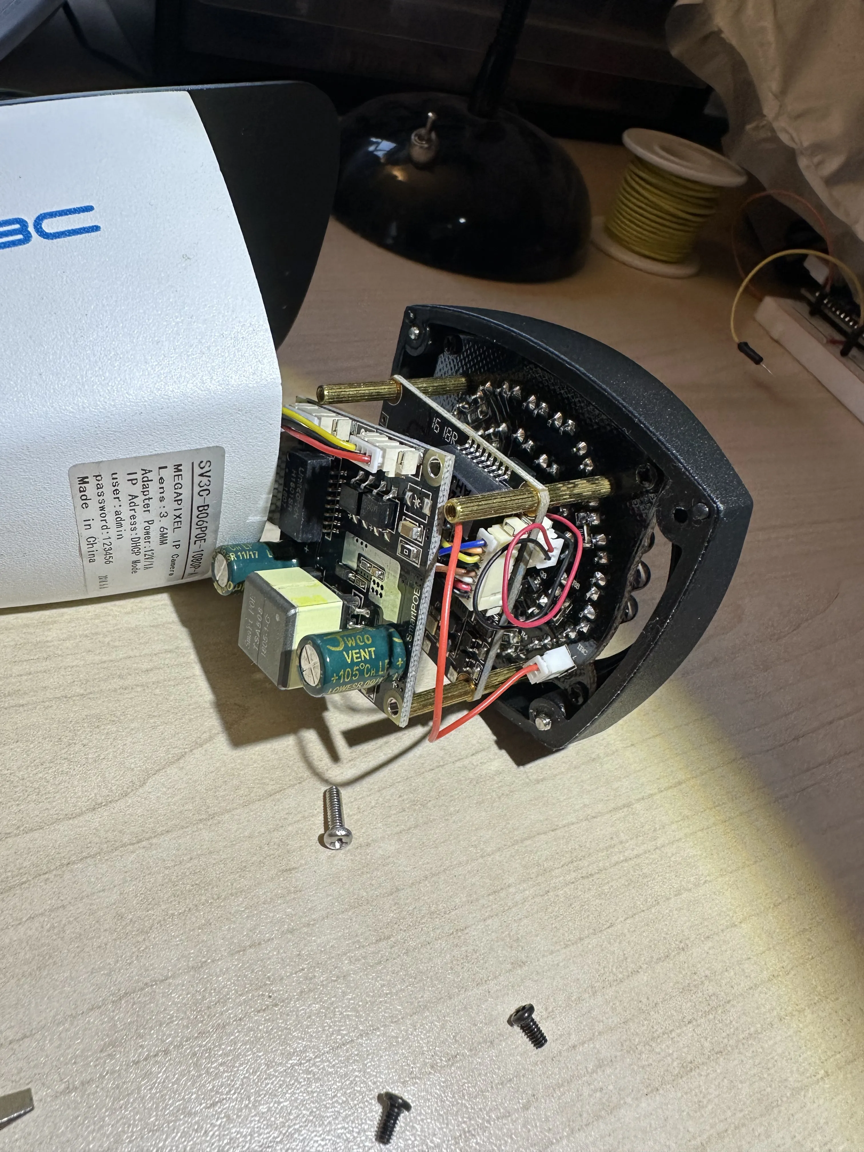 The IP camera partially dissasembled, it is made of of three PCBs inside separated by standoffs.