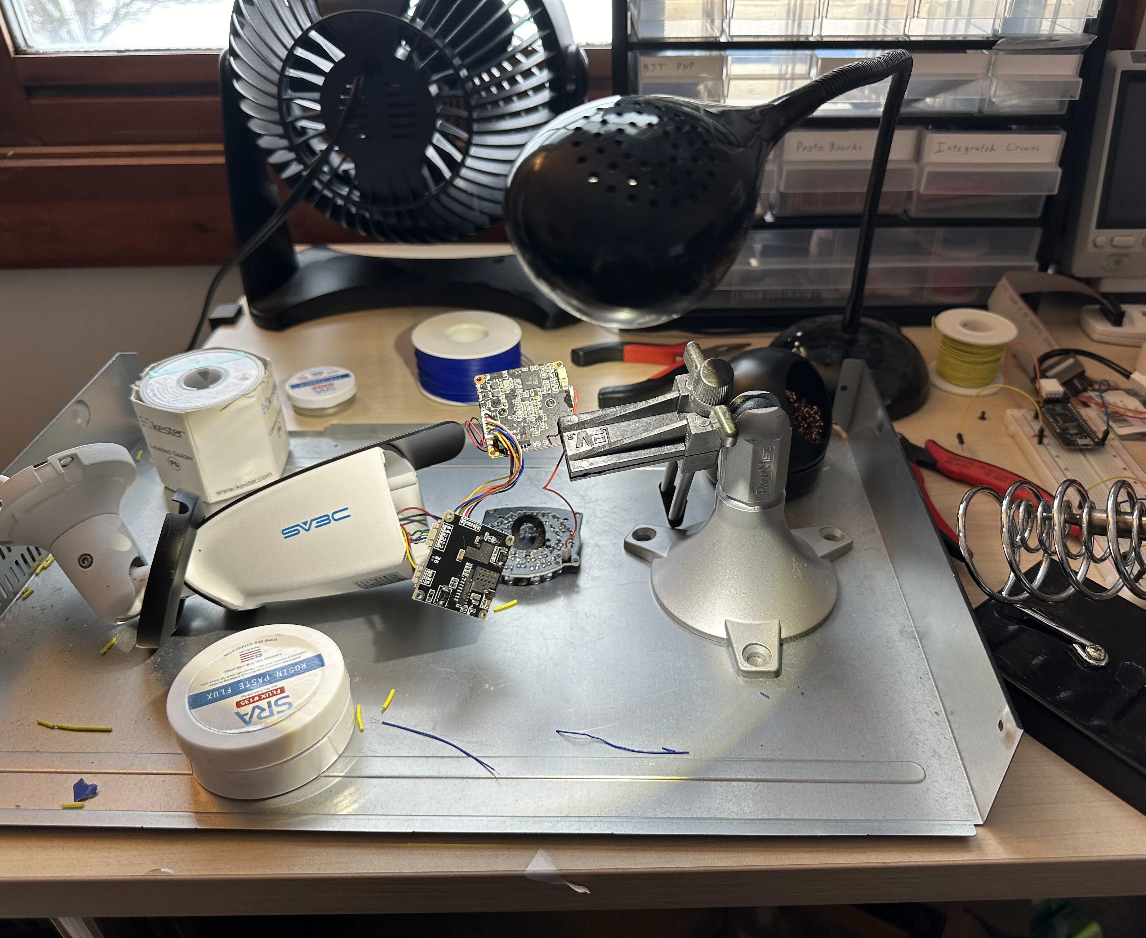 A soldering operation is occuring on the board.