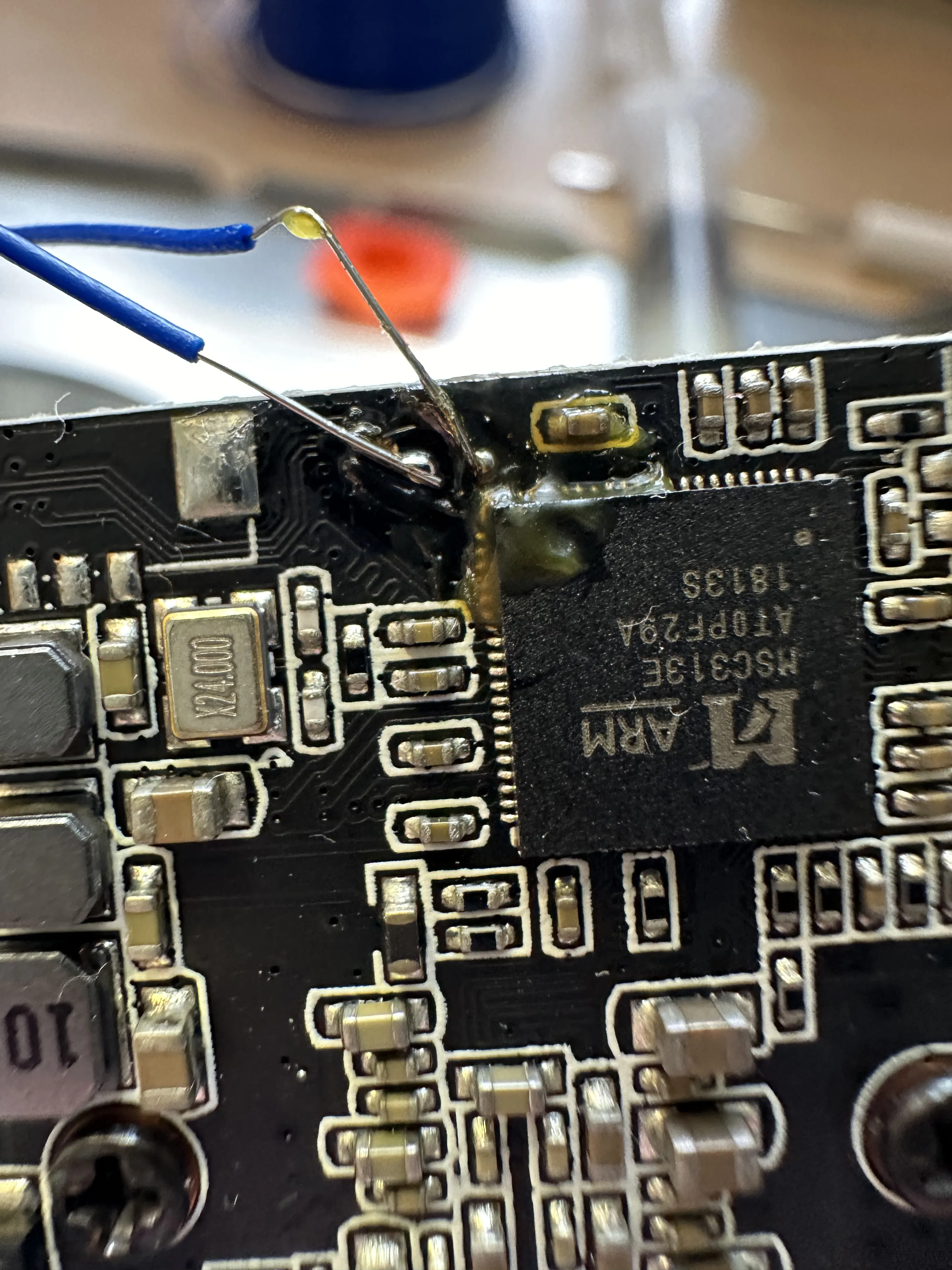 Two small wires have been soldered to the pads, BUT ZOOMED IN! AND THE LIGHTING IS DIFFERENT!!!