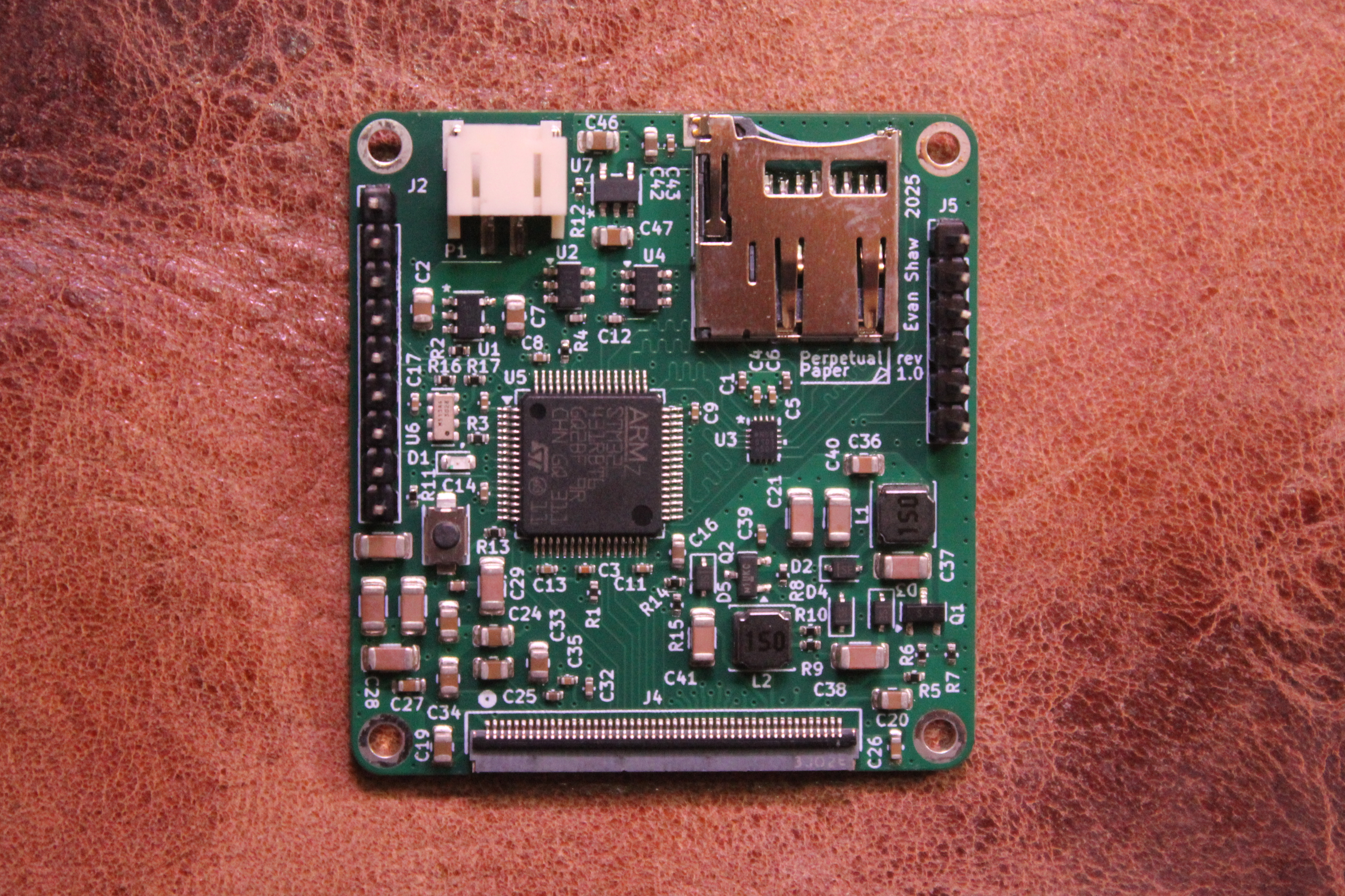 A block diagram of the final Perpetual Paper board design. At the top, a battery feds in to two regulators